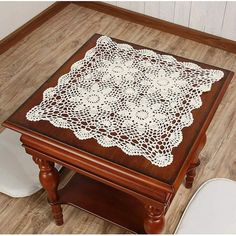 a wooden table topped with a white doily