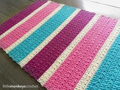 a crocheted blanket is laying on the floor