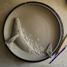 a ceramic plate with a bird on it