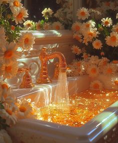 a sink filled with gold glitter next to flowers