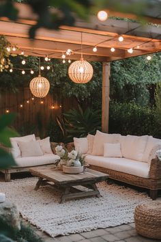 Outdoor patio with a white sectional sofa under a pergola, adorned with string lights and lanterns. Back Porch Ideas On A Budget, Small Backyard Entertaining Area, Outdoor Spaces On A Budget, Patio Rugs Outdoor Ideas, Small Backyard Oasis, Cheap Patio Ideas, Uncovered Patio, Zen Backyard Ideas, Rustic Outdoor Bar