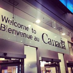 a welcome sign is displayed on the side of a building