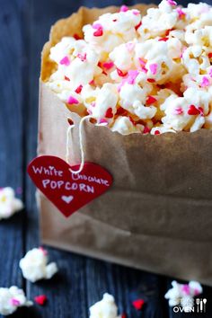 a bag filled with popcorn and sprinkles on top of a table