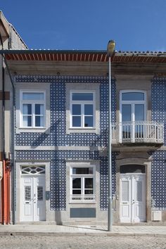 a blue and white building with two balconies