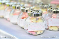 there are many small jars with candy in them