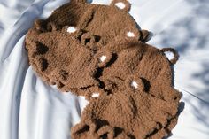 two teddy bears made out of sand on top of a bed