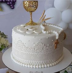 a cake decorated with white frosting and gold decorations