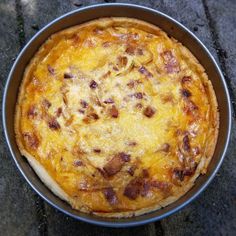 a pizza sitting in a pan on top of a table