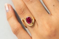 "18k Bezel Set Oval Ruby Ring,Art Deco Engagement Ring,Solid Gold Dee Curved Band,Genuine Ruby,July Birthstone Ring,Anniversary Gift for Her ★ ★ ★  CUSTOM/DUTY-FREE SHIPPING WORLDWIDE, BUYERS DON'T HAVE TO PAY ANY CUSTOM FEES WHILE IMPORTING ★ ★ ★ ★  Details ★ Made to order Material: 14k/18k Gold Color Options: Yellow Gold, White Gold, Rose Gold Stone Details:- Genuine Ruby, Oval Size: 7x9 mm Approx Weight (Ct): 1.71 ★ 100% Natural Diamond and Gemstones ★ Diamond: Round Brilliant cut, G-H Color, SI Clarity ☂ Shipped with Insured Shipping within 4-7 business days. ➦ 100% Free Returns. ➦ Our Jewelry comes with a Lifetime Warranty. (Stone Replacement not included) ✈ We offer free EXPRESS shipping across the world. ★ We can also provide a certificate along with the jewelry. However, it will be Oval Ruby Ring Designs Unique, Modern Oval Ruby Ring In Gold, Modern Gold Oval Ruby Ring, Modern Oval Gold Ruby Ring, Oval Yellow Gold Rings With Tension Setting, Oval Emerald Ring With Tension Setting In Fine Jewelry, Oval Yellow Gold Rings With Bezel Setting, Oval Birthstone Ring With Tension Setting, Oval Birthstone Ring With Polished Finish