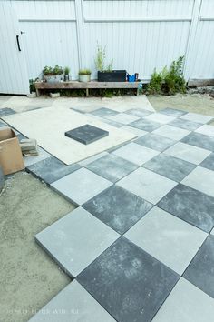 an outdoor area with cement blocks and plants