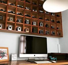 a computer monitor sitting on top of a wooden desk