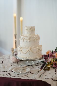 a white wedding cake sitting on top of a table