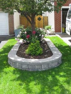 a white van parked in front of a house next to a tree and flower bed