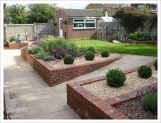 an outdoor garden with brick edging and landscaping