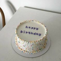 a birthday cake with the words happy birthday written on it and sprinkles