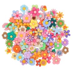 many different colored flowers and buttons on a white background