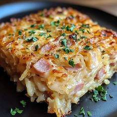 a close up of a plate of food with ham and cheese casserole on it