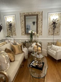 a living room with two couches and a coffee table in front of the mirror