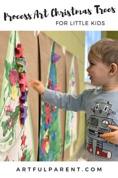 a young boy is painting on the wall with words that read process art christmas trees for little kids