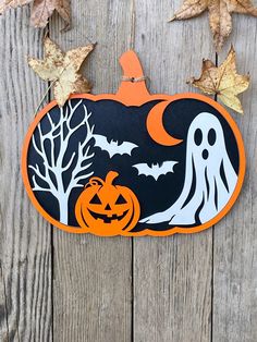 an orange and black halloween sign hanging from a wooden fence