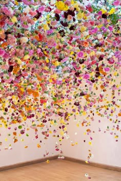 a room filled with lots of different colored confetti falling from the ceiling to the floor