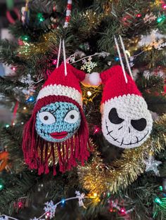 two knitted ornaments hanging from a christmas tree in the shape of jack and sally