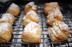 several pastries sitting on top of a grill