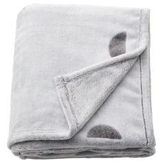 the grey and white blanket has holes in it