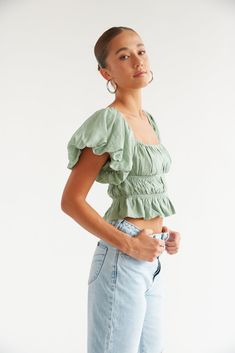 This Item is excluded from promotions. The Dottie Puff Sleeve Ruffle Crop Top is the perfect everyday top with dramatic puff sleeves that can be worn on or off the shoulders, and a tiered, cinched bodice. Featuring a square neckline and a ruffle hem. Pair with the Rolla's Heidi Jean to complete this flirty casual look. Details 80% Viscose, 20% Nylon Cropped Elastic armholes Stretchy fit Hand wash cold / Line dry Green Puff Sleeve Smocked Top, Casual Puff Sleeve Top With Ruffles And Square Neck, Trendy Puff Sleeve Top With Ruffles And Square Neck, Puff Sleeve Ruffle Crop Top For Day Out, Puff Sleeve Crop Top With Ruffles For Day Out, Billowy Puff Sleeve Ruched Tops, Trendy Cropped Puff Sleeve Top With Ruffles, Billowy Puff Sleeve Top With Smocked Back, Puff Sleeve Smocked Top With Ruffles For Day Out