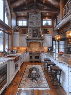 a large kitchen with white cabinets and wood flooring, along with an area rug on the floor