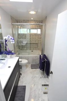 a bathroom with a sink, toilet and shower