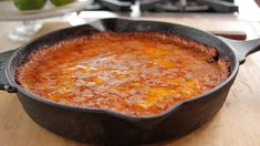 a cast iron skillet sitting on top of a wooden table