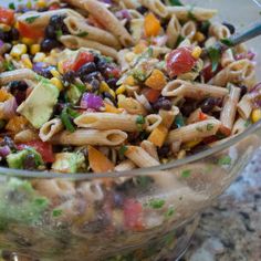 a bowl filled with pasta salad on top of a table