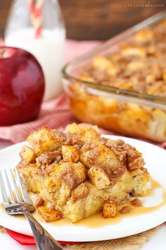 a white plate topped with bread pudding next to an apple and cinnamon roll casserole