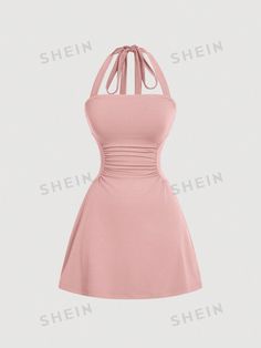 a pink dress with a bow at the neckline and an open back, on a white background