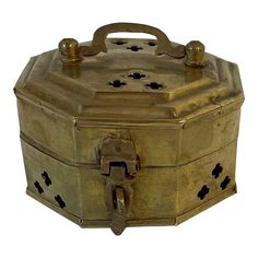 an old metal box with holes and handles