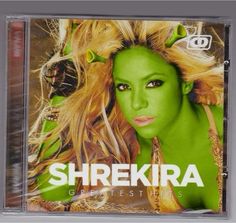 shekira greatest hits cd cover with blonde hair and green makeup on her face