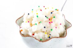 a bowl filled with whipped cream and sprinkles