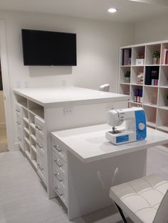 a sewing machine sitting on top of a white counter next to a book shelf filled with books