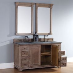 a bathroom vanity with two mirrors above it