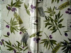 the fabric has flowers on it with green leaves and purple berries, along with words that read happy mother