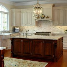 a large kitchen with an island in the middle and lots of cabinets on both sides