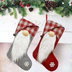 two christmas stockings hanging from a mantel