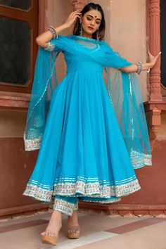 Vibrant colours are a must in every wardrobe, and our our sky blue pure cotton anarkali set is definitely one of them. The soft net dupatta with beautiful lace work and hand embellished stone work all over the dupatta .Perfect for the festive season, this gorgeous anarkali set will surely make you look different and unique in every occasion you go! PRODUCT DESCRIPTION: Kurta & Pant: Cotton Dupatta: Soft Net Color: Sky Blue No. Of Components : Set of 3 Embroidery Details: Lace Work Wash Care : Dr Light Blue Anarkali Suits, Kurta Designs For Short Height Women, Sky Blue Gown Indian, Sky Blue Dress Indian, Sky Blue Anarkali Dresses, Sky Blue Suits Women Indian, Sky Blue Colour Dress, Sky Blue Kurti, Pomcha Jaipur