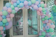 a bunch of balloons that are in front of a door