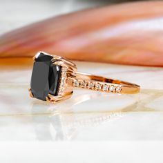 a black diamond ring sitting on top of a table