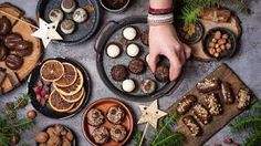 a table topped with plates and trays filled with different types of food on top of it