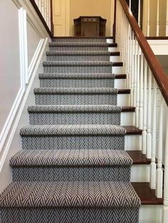 the stairs are painted blue and white with herringbone carpet