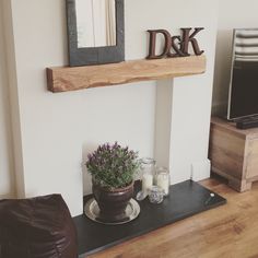 a living room with a tv, coffee table and other items on the shelf in front of it