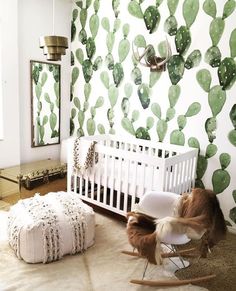 a baby's room with cactus wallpaper and rocking chair